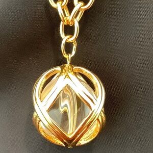 Chunky Gold tone 30 1/2” Chain With Caged Pendant Encompassing A Clear Ball